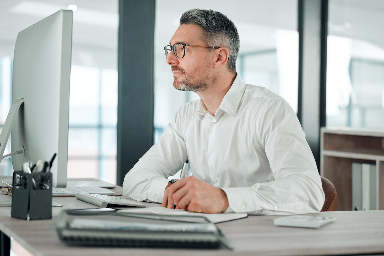 Businessman, computer and thinking on email, reading and analysis for information, research and work. Mature business person, technology and planning for project, notebook and future company growth.